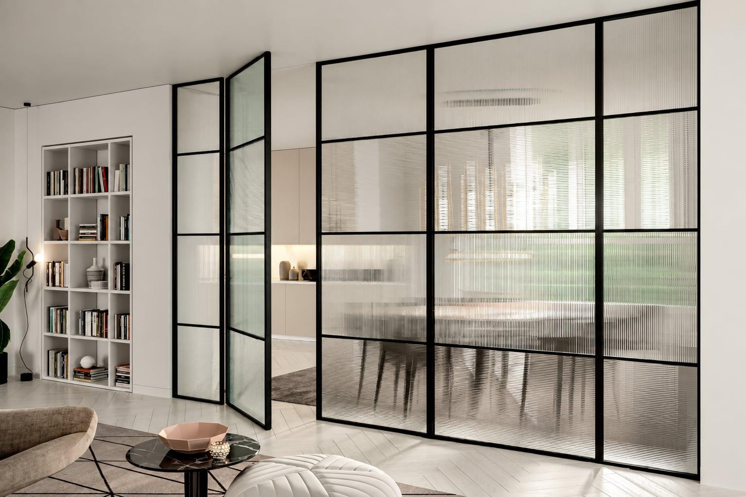 Living room divided by black-framed reeded glass partitions