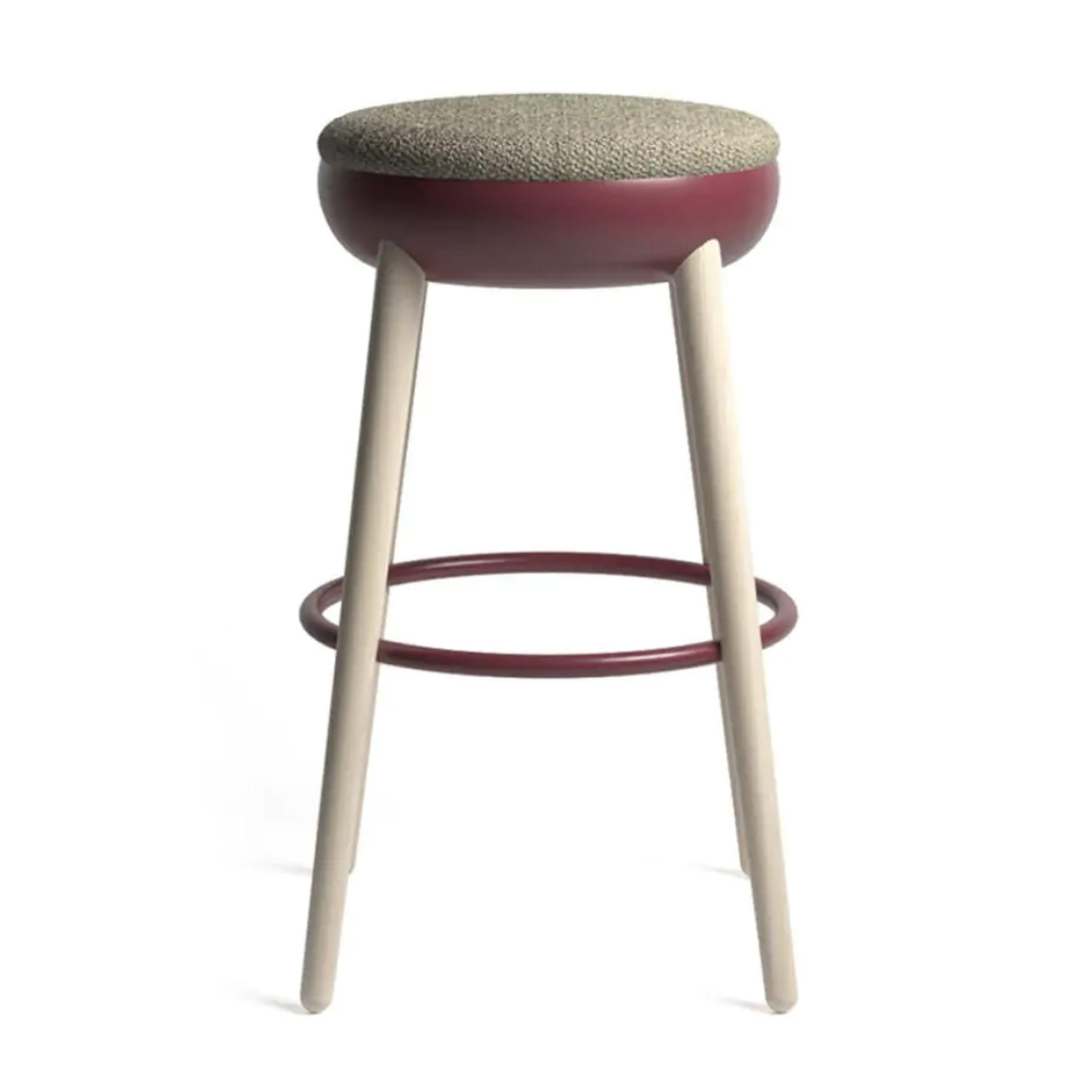 Stool with a burgundy ring, pale wood legs and a grey upholstered seat