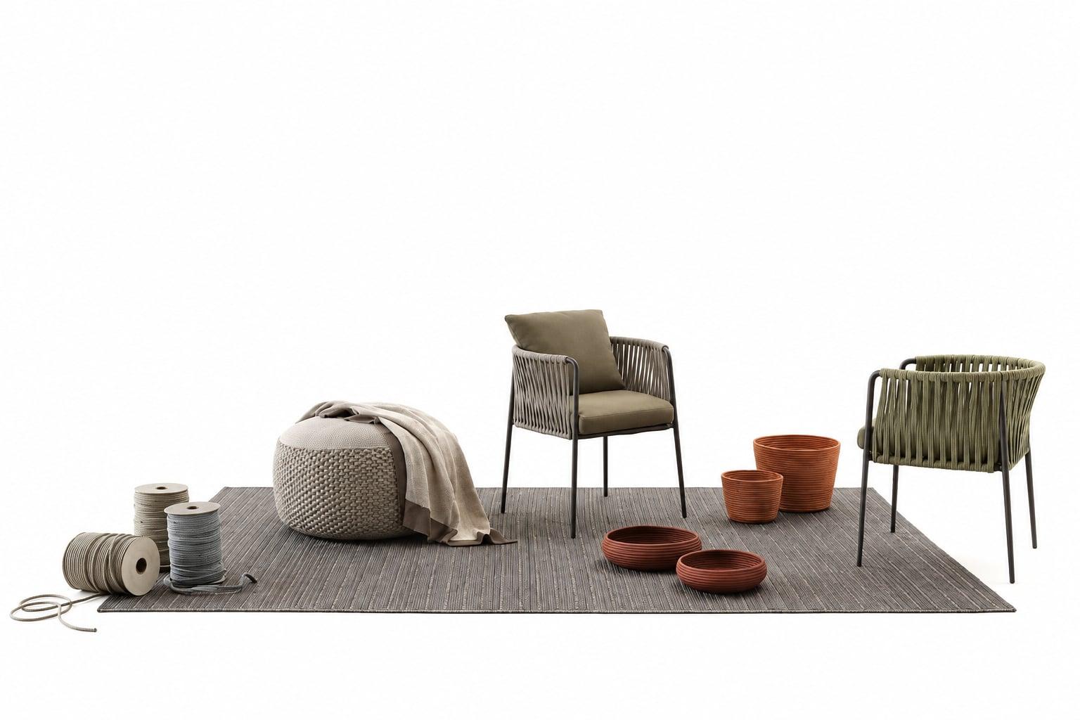 Outdoor armchairs, a pouf, a blanket and terracotta pots on a grey rug