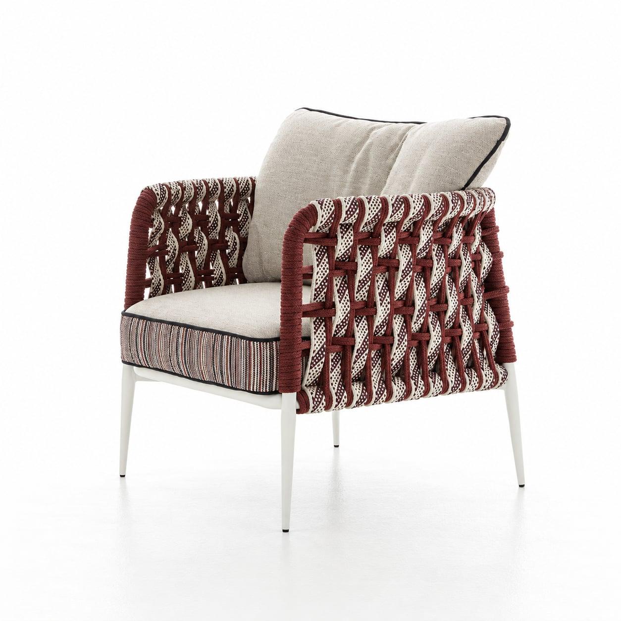 Outdoor armchair with a burgundy patterned weave and cream cushions