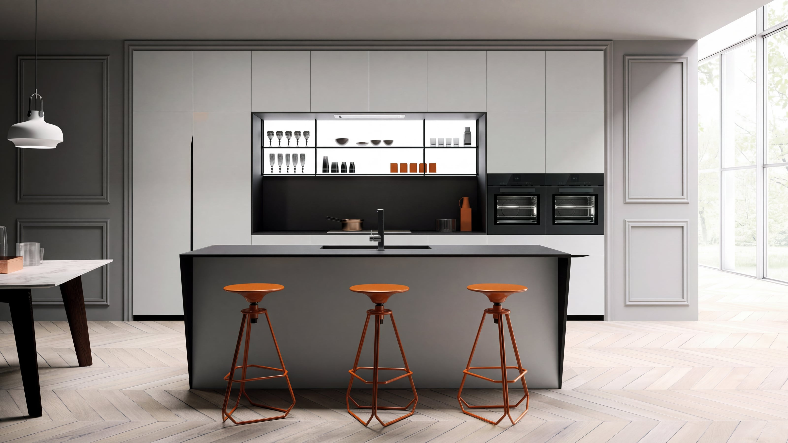 Kitchen with a grey island and orange stools in front of white handleless cabinetry with a backlit glass niche