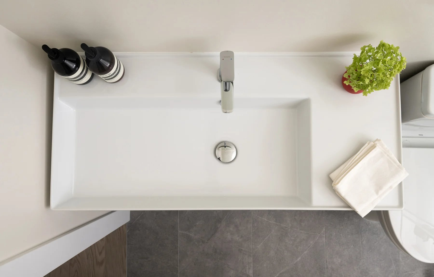 Oak vanity with a rectangular basin under a half-moon backlit mirror