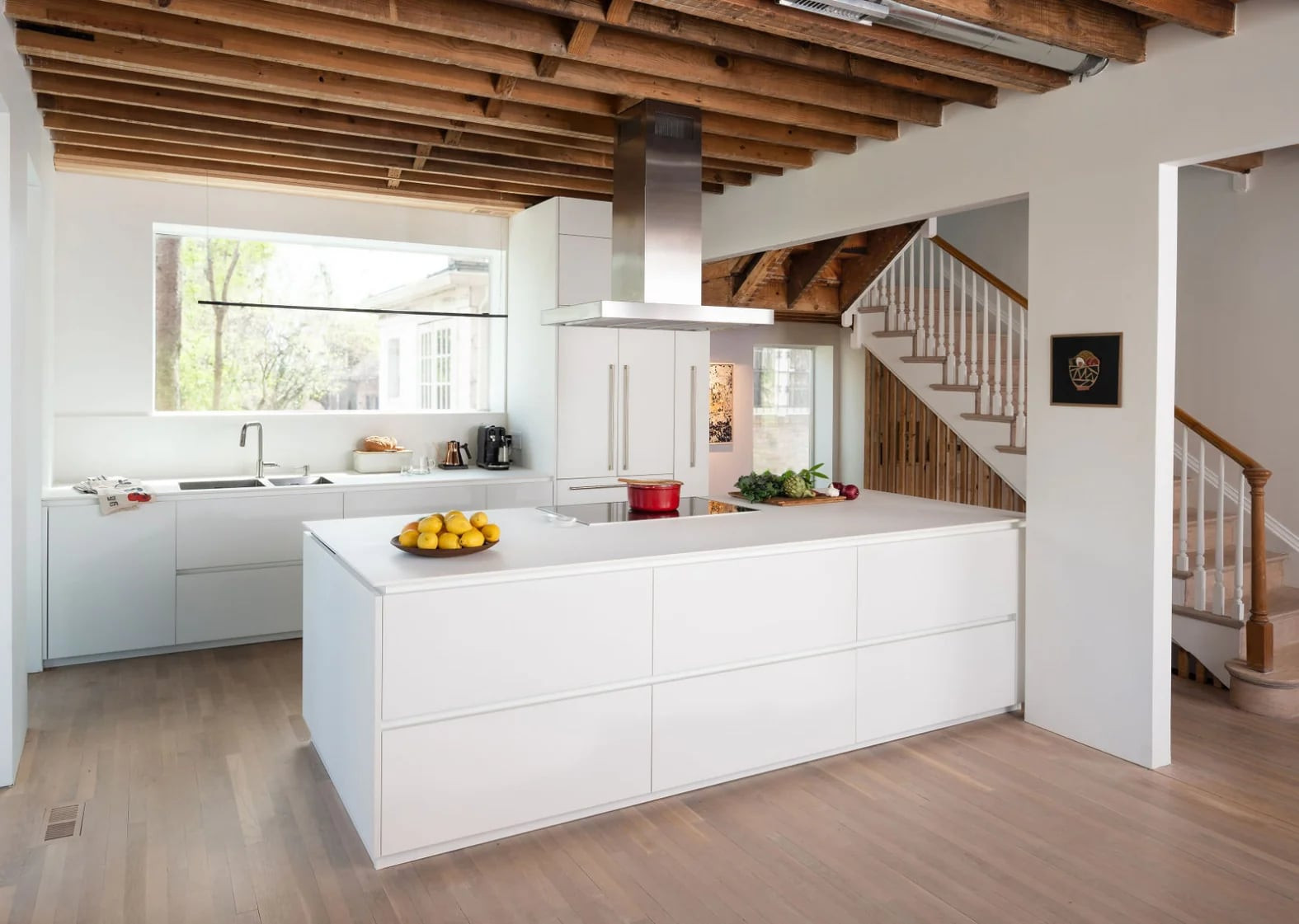 Gloss white and oak galley kitchen with a stainless-steel range